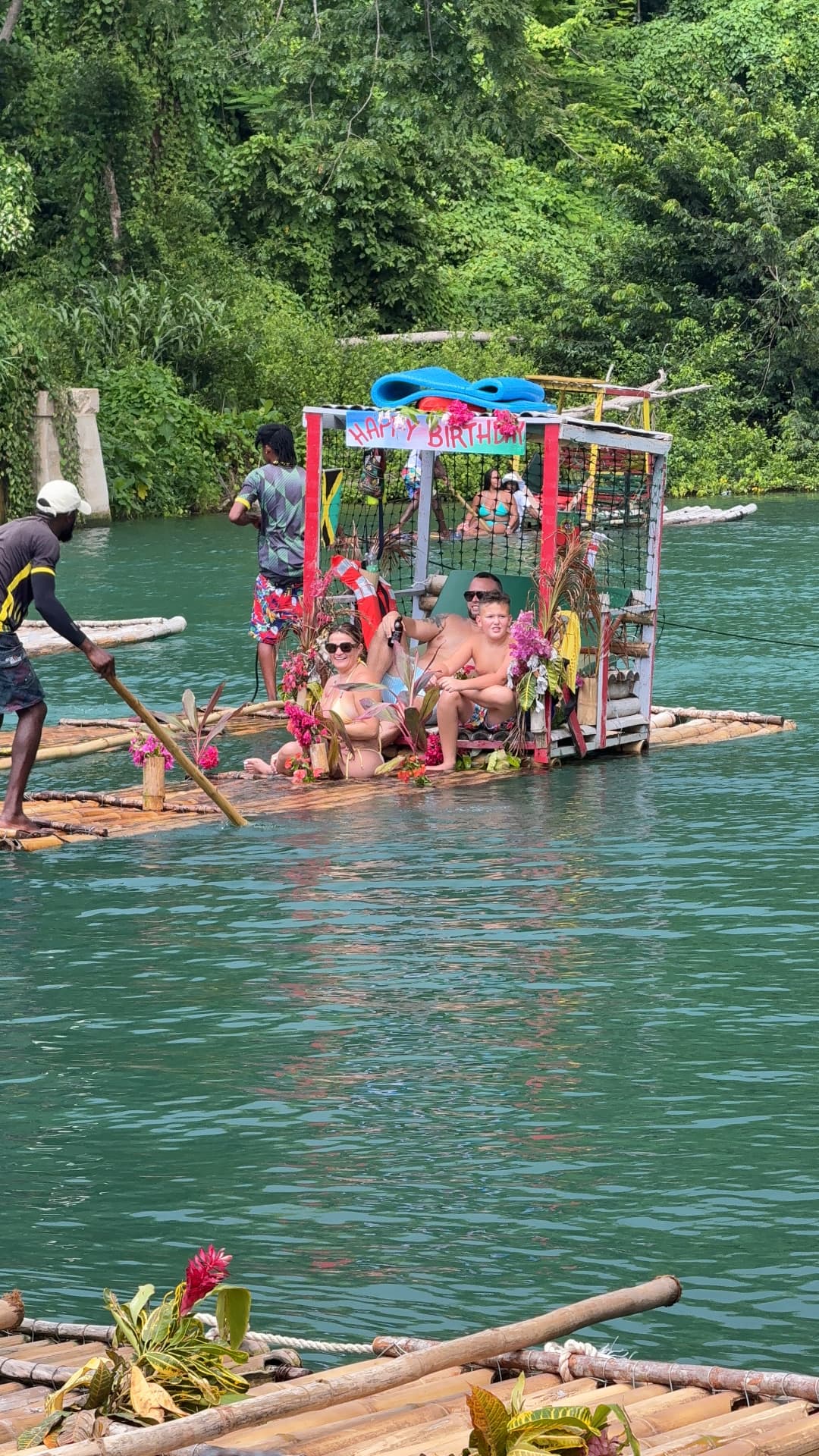 Guests on a decorated bamboo raft on the river